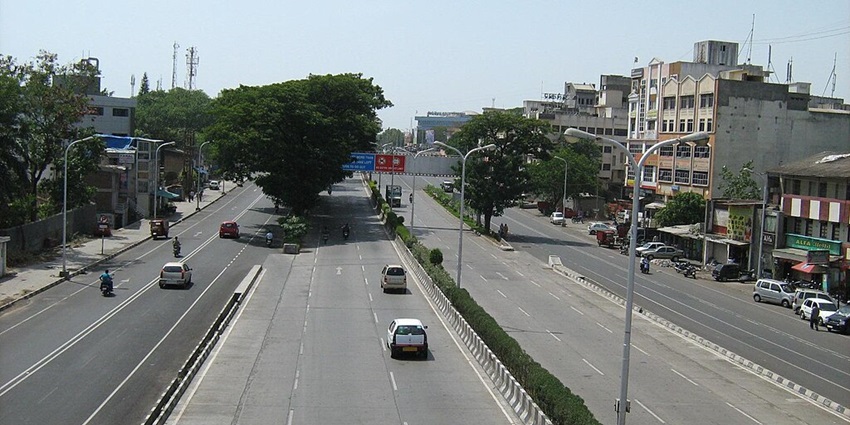 A view of the Old Pune-Mumbai Highway surrounded by hills and greenery
