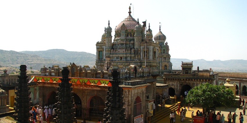 Aerial view of the temple building and the courtyard inside with tourists wandering all around