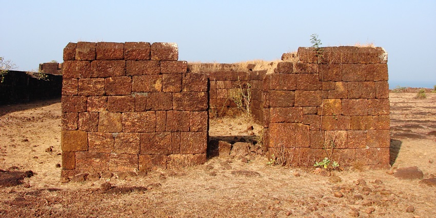 Remnants of stone structures at Devgad Fort, showcasing its historical architecture