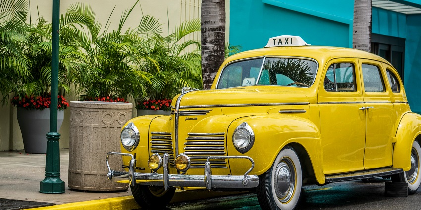 An image of a taxi to reach Jungle Water Park which is accessible by cars, roads and buses.