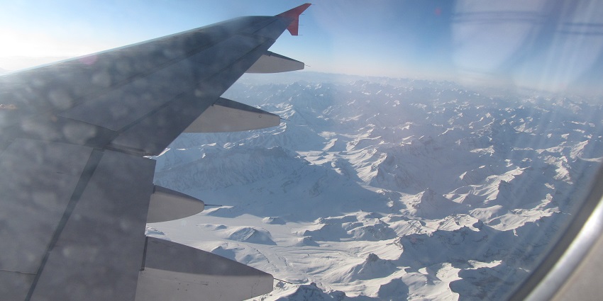  Image of Delhi-Leh flight aerial view with snow capped mountains and clear blue sky