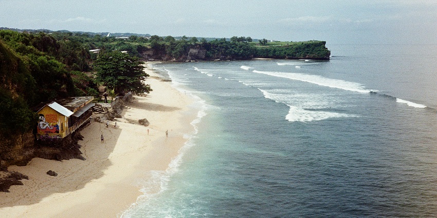 An image of the road leading to Balangan Beach with greenery and open skies.