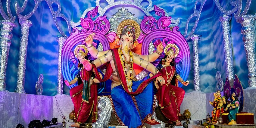 A picture of a tall idol of Lord Ganesha at a Ganesh Chaturthi celebration