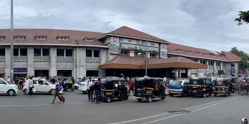 A panoramic view of Pune Junction railway station with people walking in the background