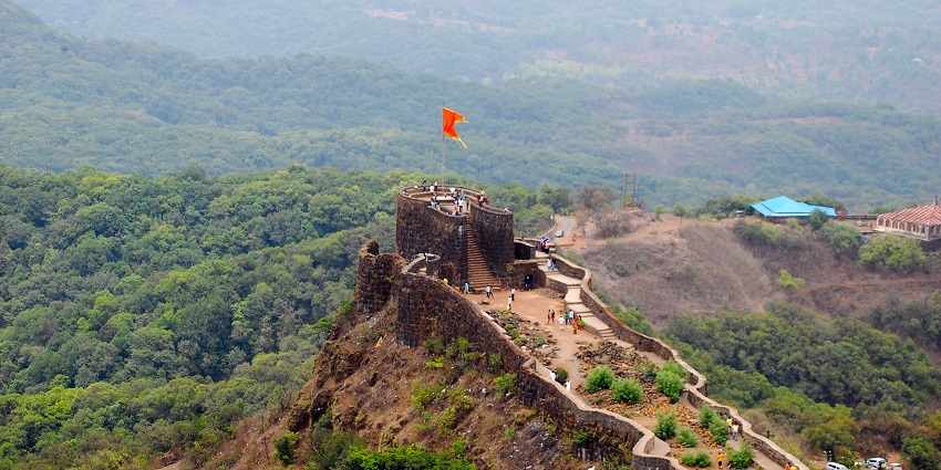 View of Pandavgad Fort at the cliff, surrounded by lush greenery