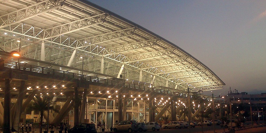 An outer view of Chennai International Airport with the terminal buildings and surrounding landscape.