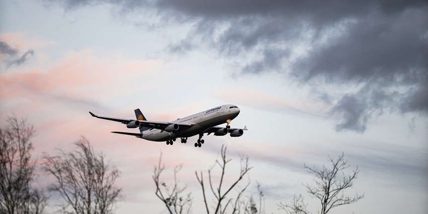 An aeroplane soars through a clear blue sky, showcasing the thrill of flight travel.