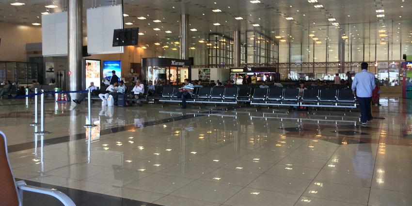 Spacious departure lounge at Pune Airport, featuring modern seating and bright lighting.