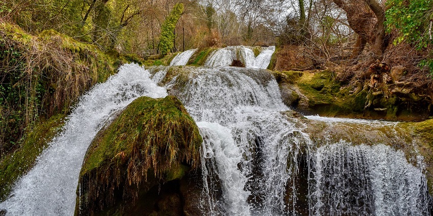 Breathtaking view of Waghora Waterfall amidst rocky mountains and flowing water.