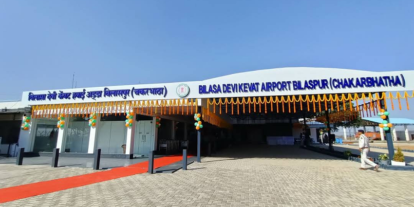 An entrance of Bilasa Devi Kevat Airport is decorated with flowers and has a red carpet