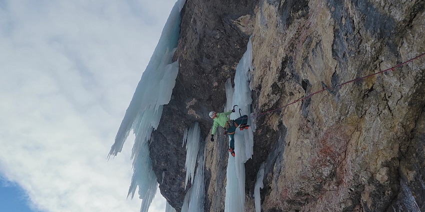 A climber navigates a mixed climbing route, showcasing skill and adventure.