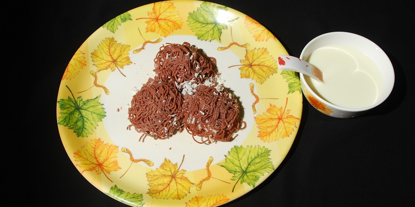 An image of Idiyappam - a soft, steamed rice noodle dish typically served with curries.