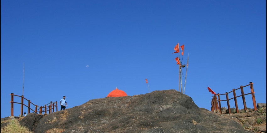 View of the Kalsubai summit, with a flag flapping at the very top