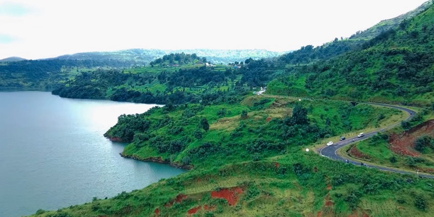 An aerial view of a majestic hill station in Maharashtra with a scenic lake along the valley