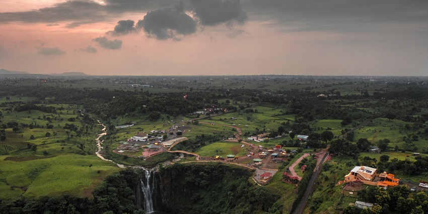 An aerial picture of a waterfall in Indore, surrounded by lush greenery all around