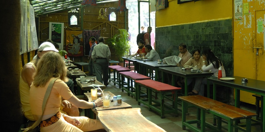 View of German Bakery in Pune with outdoor seating and colourful umbrellas.