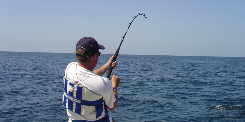 A picture of a tourist fishing around the Agatti island with the local fishermen