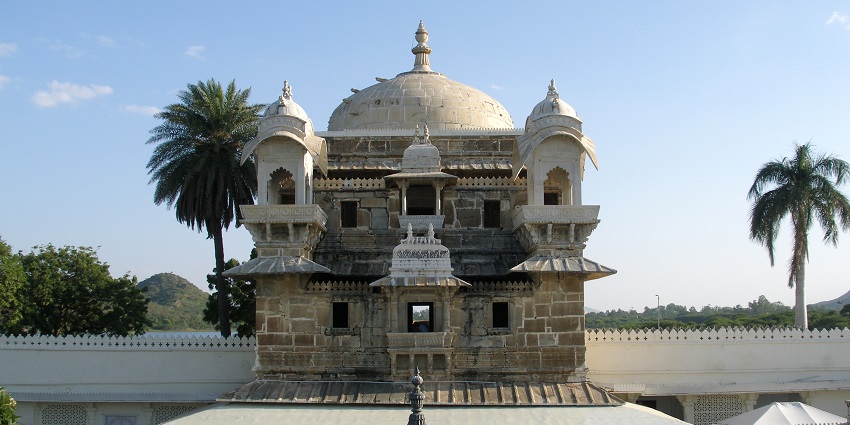 Jag Mandir Palace, reflecting its stunning architecture on the waters of Lake Pichola