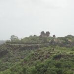 Jai Vilas Jawhar Fort features historic architecture, lush gardens, and panoramic views