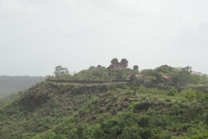 Jai Vilas Jawhar Fort features historic architecture, lush gardens, and panoramic views