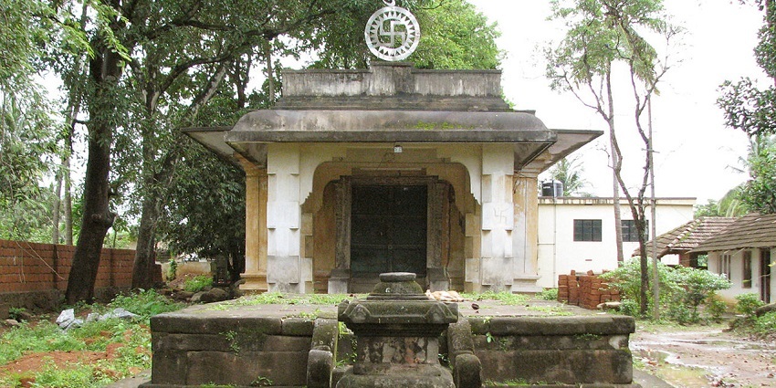Jain temple features a serene reflection spot with intricate marble carvings.