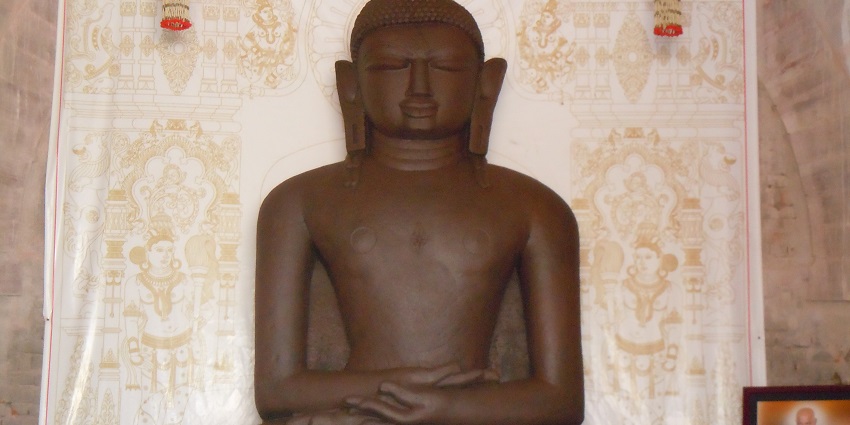 Marble statue of Lord Adinath, the first Tirthankara in Jainism, seated in a meditative posture