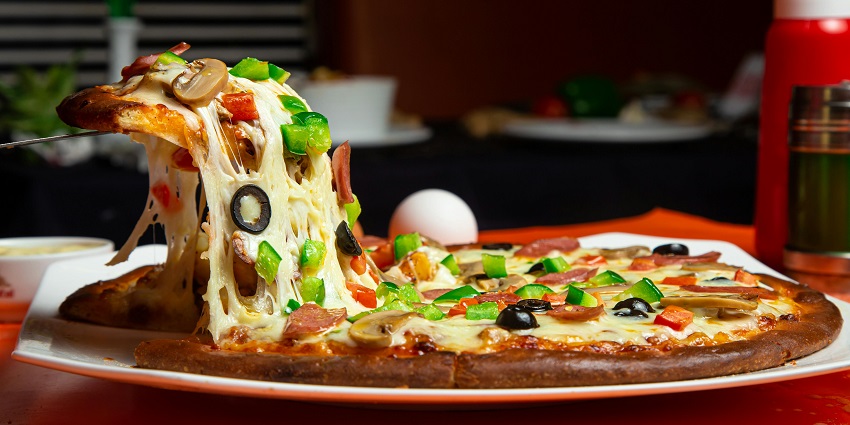 A mouthwatering pizza topped with fresh mushrooms, a golden crust and cheese.