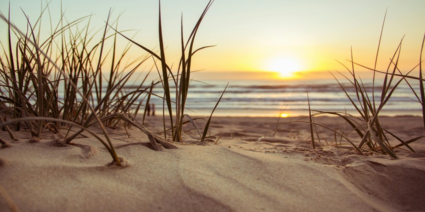 Sunset over green fields near Kashid Beach, highlighting peaceful places nearby