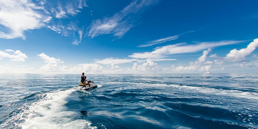 View of jet skiers touring through waves in Ganpatipule while having an adrenaline rush.