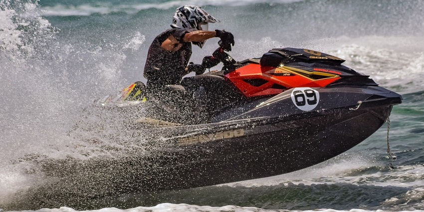 A picture of a person on a thrilling jet ski ride across the waves at Alibaug Beach.