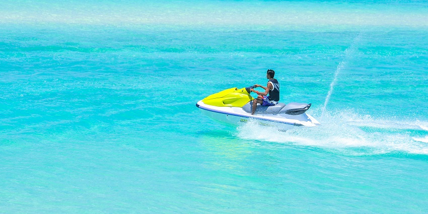 An image of a jet skier speeding across Lavasa's lake, surrounded by lush hills.