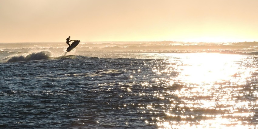 Image of a person jet skiing during beautiful sunset hour - one of the best things to do in Nusa Dua