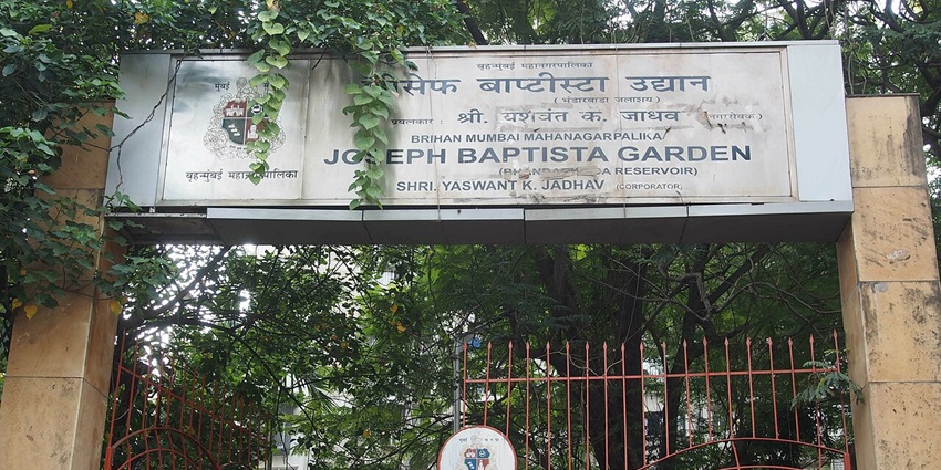 Historic entrance gate of Joseph Baptista Garden in Mumbai, surrounded by greenery, one of the best places to visit near Marine Drive.