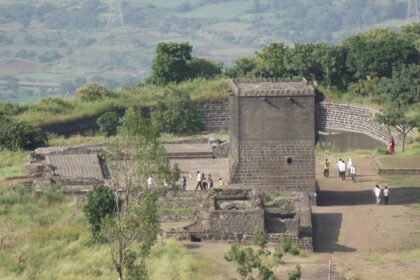 Picturesque view of an ancient fort surrounded by lush greenery and hills