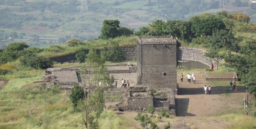 Picturesque view of an ancient fort surrounded by lush greenery and hills