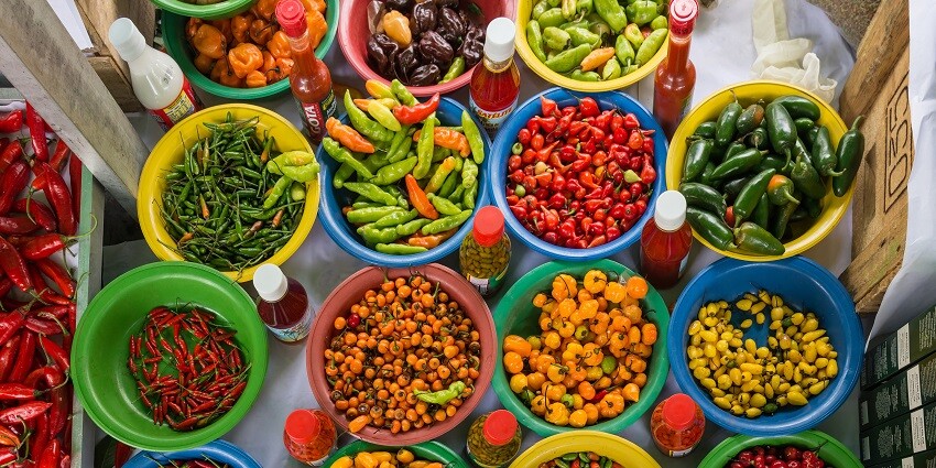 A vibrant display of a variety of fruits and vegetables in a flea market.