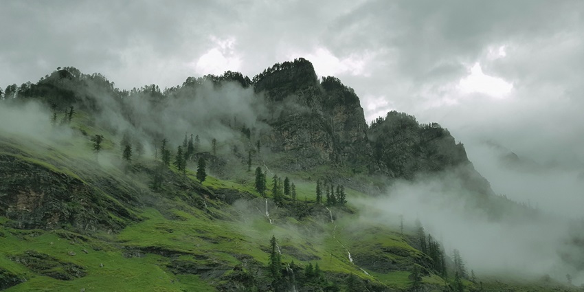 Majestic view of the lush hills of Kaas plateau with mist surrounding