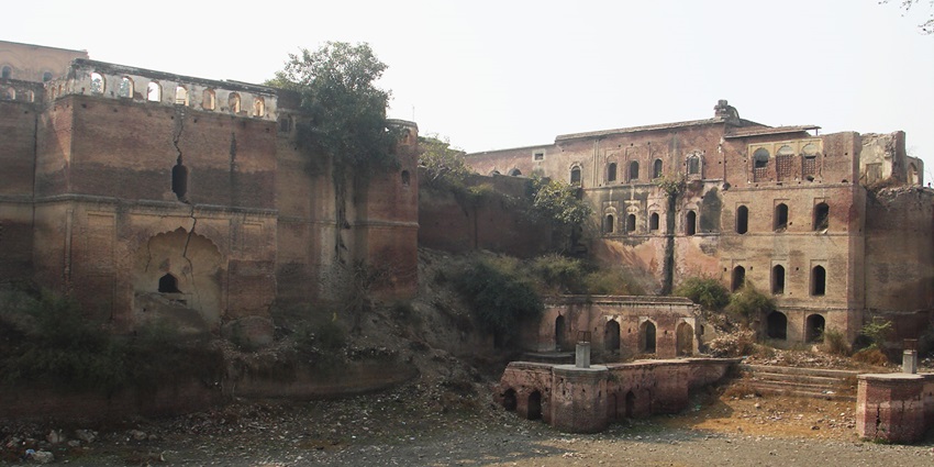 A picture of the ruins of the fort of Kaithal surrounded by greenery and trees