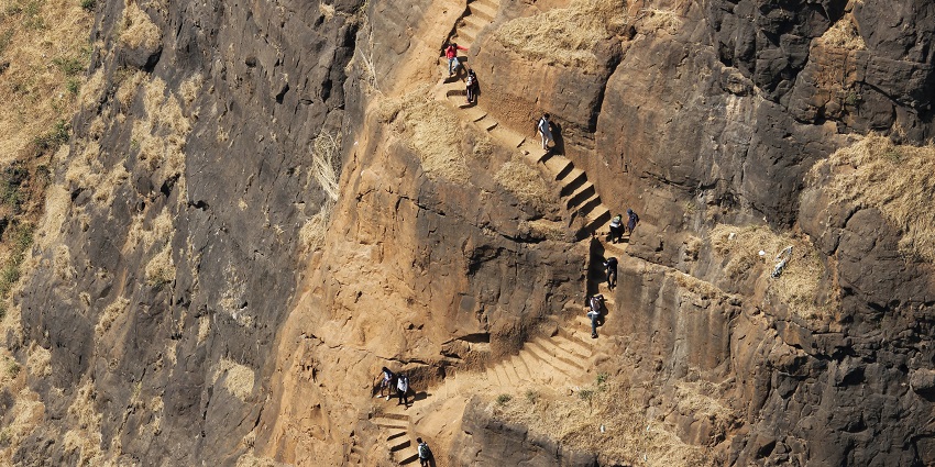View of tourists climbing the challenging trek of Kalavantin Durg