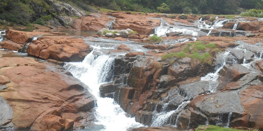 Stunning waterfall surrounded by lush greenery and scenic beauty