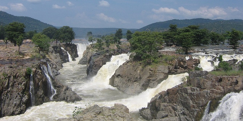 Majestic waterfall nestled in lush forests, perfect for exploration.