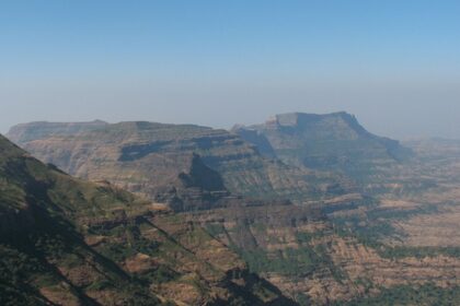 View of Alang, Madan, and Kulang peaks from Kalsubai, Maharashtra, under blue skies