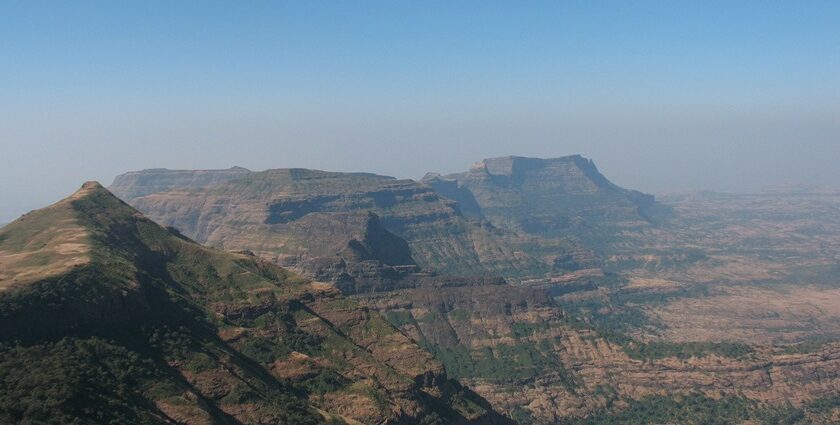 View of Alang, Madan, and Kulang peaks from Kalsubai, Maharashtra, under blue skies