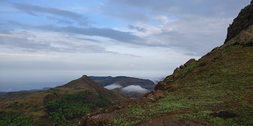 View from Kalsubai Peak, one of the best places near Alang Fort, showcasing mountains.