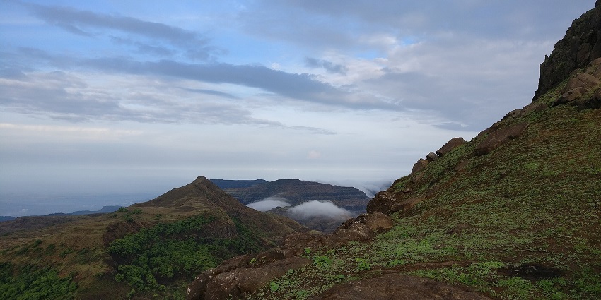 Surreal image of the Kalsubai Peak, the highest point in Maharashtra, covered by the fog
