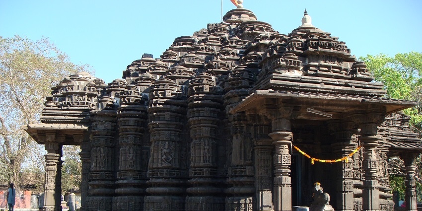 Serene temple with greenery, intricate carvings, and spiritual ambiance
