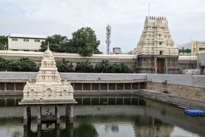 Close-up of Kamakshi Amman Temple with its intricate carvings and a holy pond