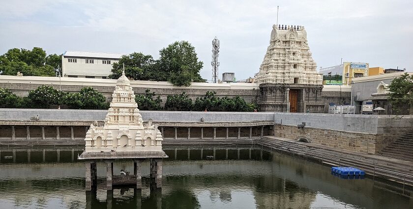 Close-up of Kamakshi Amman Temple with its intricate carvings and a holy pond