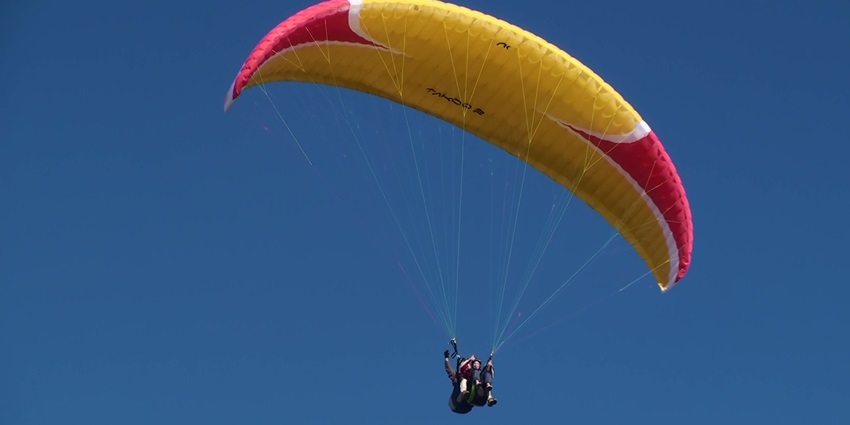 Paraglider flying over a scenic landscape, one of the tourist attractions near Mumbai.