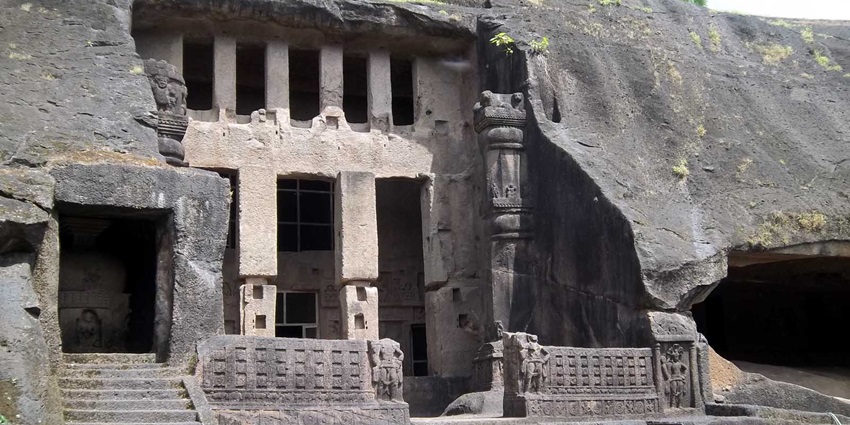 Ancient Kanheri Buddhist Cave No. 3 with stone pillars and carved entrance in Mumbai.